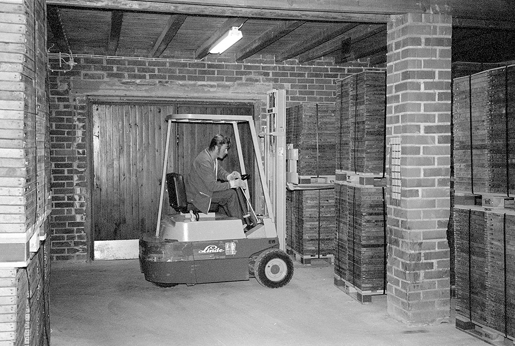 A person lifts auger core boxes with a forklift