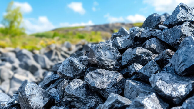 Pile of raw nickel ore before processing. Nickel mining, pile of raw nickel pieces against the background of natural landscape.