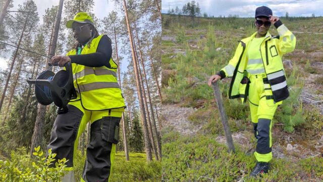 Two women standing in forest environment. Both have yellow working cloths on.