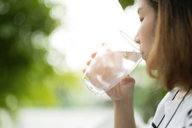 closeup hand drinking fresh water, healthcare concept