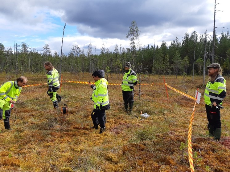 People in the swamp prepairing equipments for testing