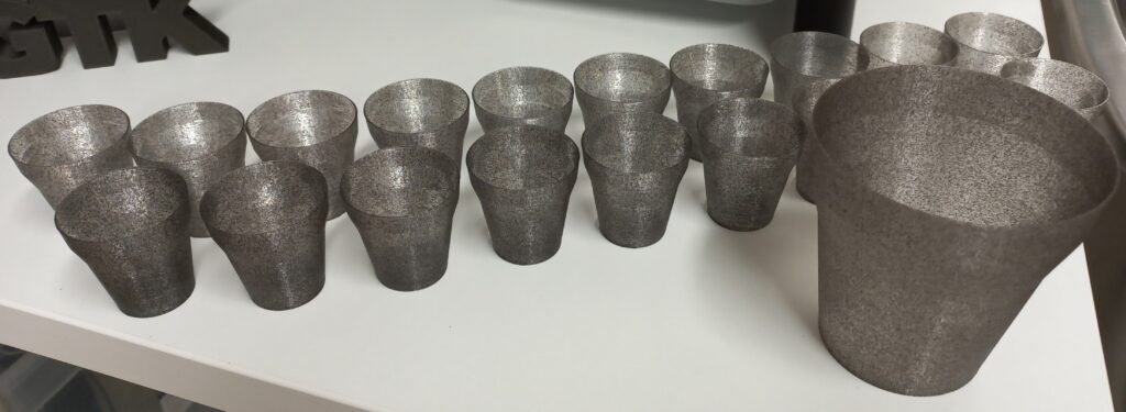 Several 3d printed pots in a row.