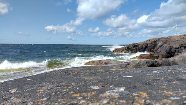 The waves of the Baltic Sea crashing against bedrock in sunny Åland.